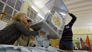 Image: Members of a local election commission empty a ballot box