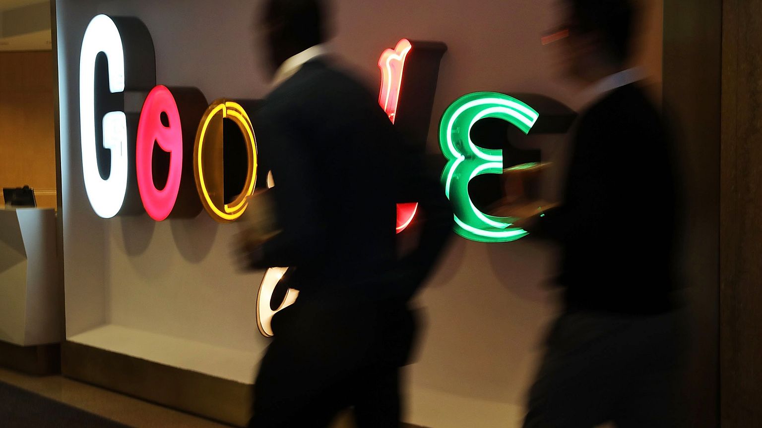 Image: People walk into Google's New York offices