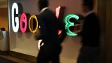 Image: People walk into Google's New York offices