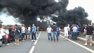 French ferry workers burn tyres to block Calais port