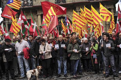 Pro-independence demonstrators of Catalonia and Basque Country raise their regional flags in Pamplona, northern Spain, on Nov. 9, 2014. 