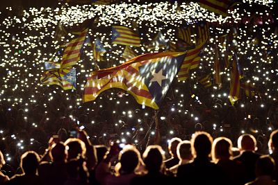 Pro-independence supporters wave "estelada" or pro independence flags during a rally of "Junts pel Si" or "Together for YES" in Barcelona, Spain on Sept. 25, 2015.