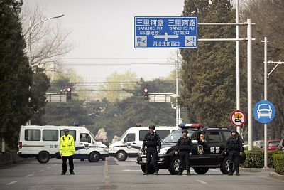 Police in tactical gear block a road leading to the Diaoyutai State Guesthouse on Tuesday in Beijing.