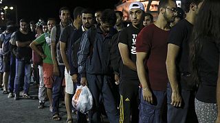 Syria refugees begin boarding Greek passenger ship in Kos