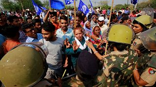 Image: Police try to stop dalit community members during a protest