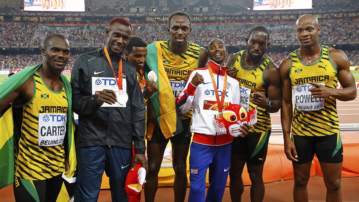Bolt celebrates triple triumph at world championships