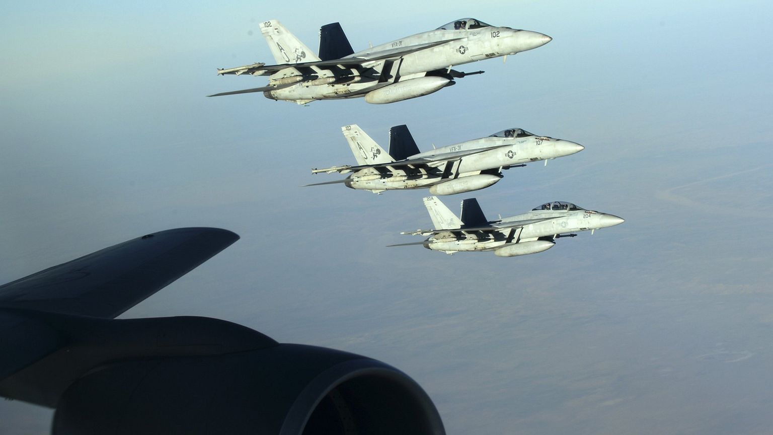 Image: A formation of U.S. Navy F-18E Super Hornets leaves after receiving 