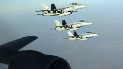 Image: A formation of U.S. Navy F-18E Super Hornets leaves after receiving 