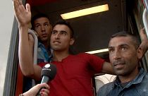 Exhausted and confused migrants board trains they hope will get them closer to Germany