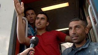 Exhausted and confused migrants board trains they hope will get them closer to Germany