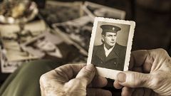 Senior woman holding dear photograph of her husband