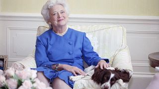 Image: First Lady Barbara Bush poses with her dog Millie in 1990.