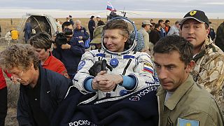 Record-breaking Russian cosmonaut returns to Earth