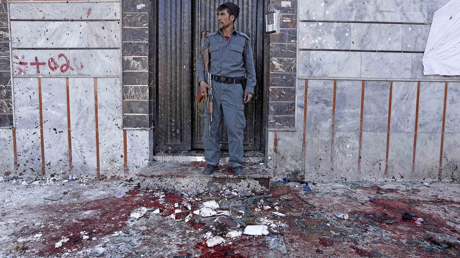 Image: At least nine killed and dozens in suicide bomb attack at voter regi