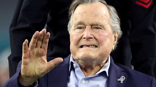 Image: Former U.S. President George H.W. Bush arrives on the field ahead of