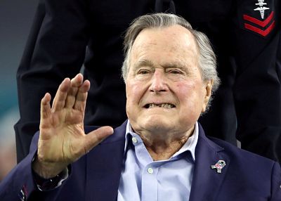 Former President George H.W. Bush arrives on the field to do the coin toss ahead of Super Bowl LI between the New England Patriots and the Atlanta Falcons on Feb. 5, 2017, in Houston
