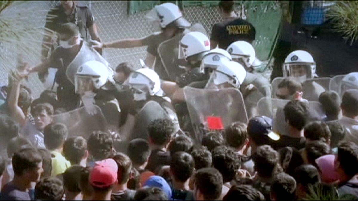 Riot police clash with migrants as tension rises in Lesbos