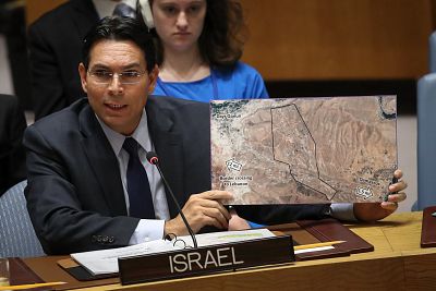 Israeli ambassador to the United Nations Danny Danon holds a map that he claims shows the area in Syria where Iran is recruiting and training 80,000 Shiite fighters at a base five miles from Damascus.