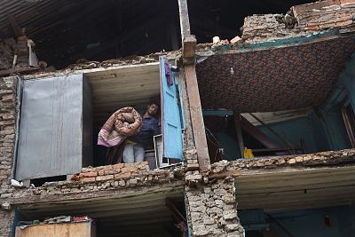 A resident carries his belongings retrieved from the ruins of his home after Saturday\'s earthquake in Bhaktapur, Nepal, on April 28, 2015.