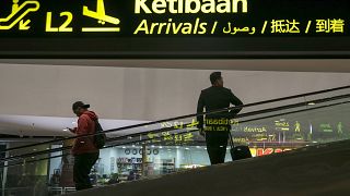 Image: People move inside the Kuala Lumpur International Airport, Malaysia,