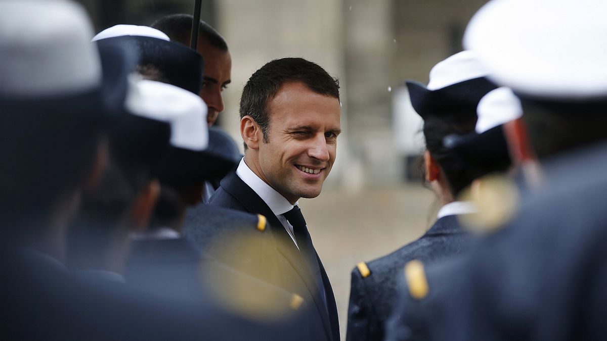 Image: France's President Emmanuel Macron reviews troops