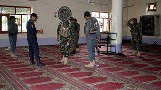 Image: Police inspect a mosque after a blast in Khost province, Afghanistan