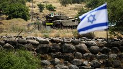 Image: An Israeli tank can be seen near the Israeli side of the border with
