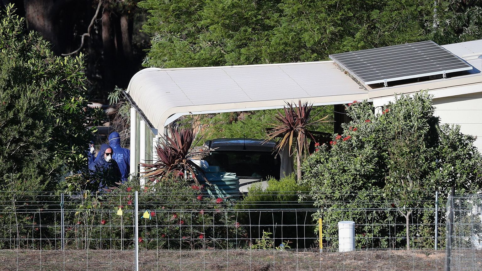 Image: Police forensics investigate the death of seven people