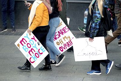 Protesters carry signs calling for the repeal of the Eighth Amendment during at rally in Dublin on March 8.