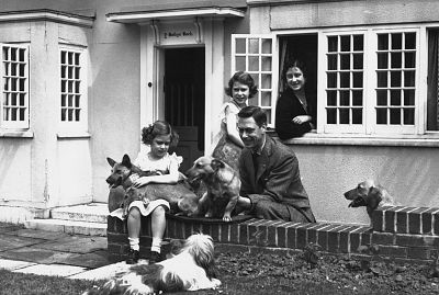 King George VI and Queen Elizabeth with Princesses Margaret, left, and Elizabeth at the Welsh House, a miniature cottage in the grounds of Windsor Castle, in 1931.