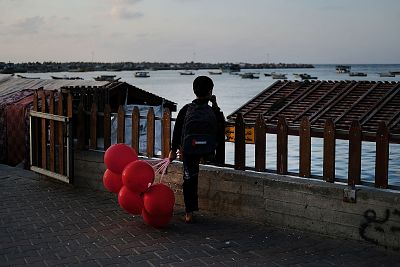 A child looks out at the sea at a fishing port in Gaza City on Saturday.