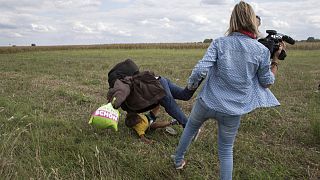 Hungarian camerawoman vilified for tripping a migrant, plans to sue