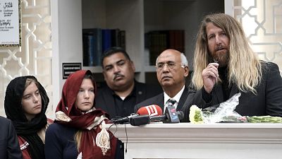 Jason Cogburn, right, speaks as his wife, Joleen, left, and daughter, Jaelyn, far left, listen during a funeral for Pakistani exchange student Sabika Sheikh, who was killed in the Santa Fe High School shooting, during a service Sunday at the Brand Lane Islamic Center  in Stafford, Texas.