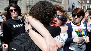 Image: Two women embrace as they wait for the official result of the Aborti