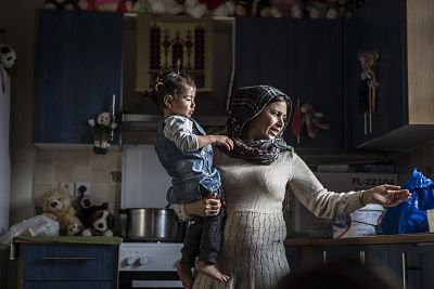 Golroz Tajik with her daughter in their kitchen in the suburbs of Athens.