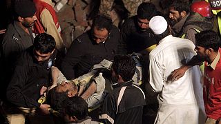 At least 16 dead and dozens trapped in Pakistan factory collapse