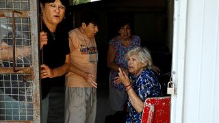 Image: Women react after a siren is sounded, in a Kibbutz on the Israeli si