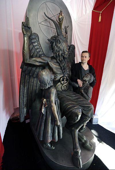 Lucien Greaves next to a nine-foot statue of the goat-headed idol Baphomet at the headquarters of the Satanic Temple in Salem, Massachusetts.