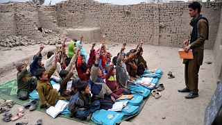 Image: Afghan school children study at an open classroom in the outskirts o