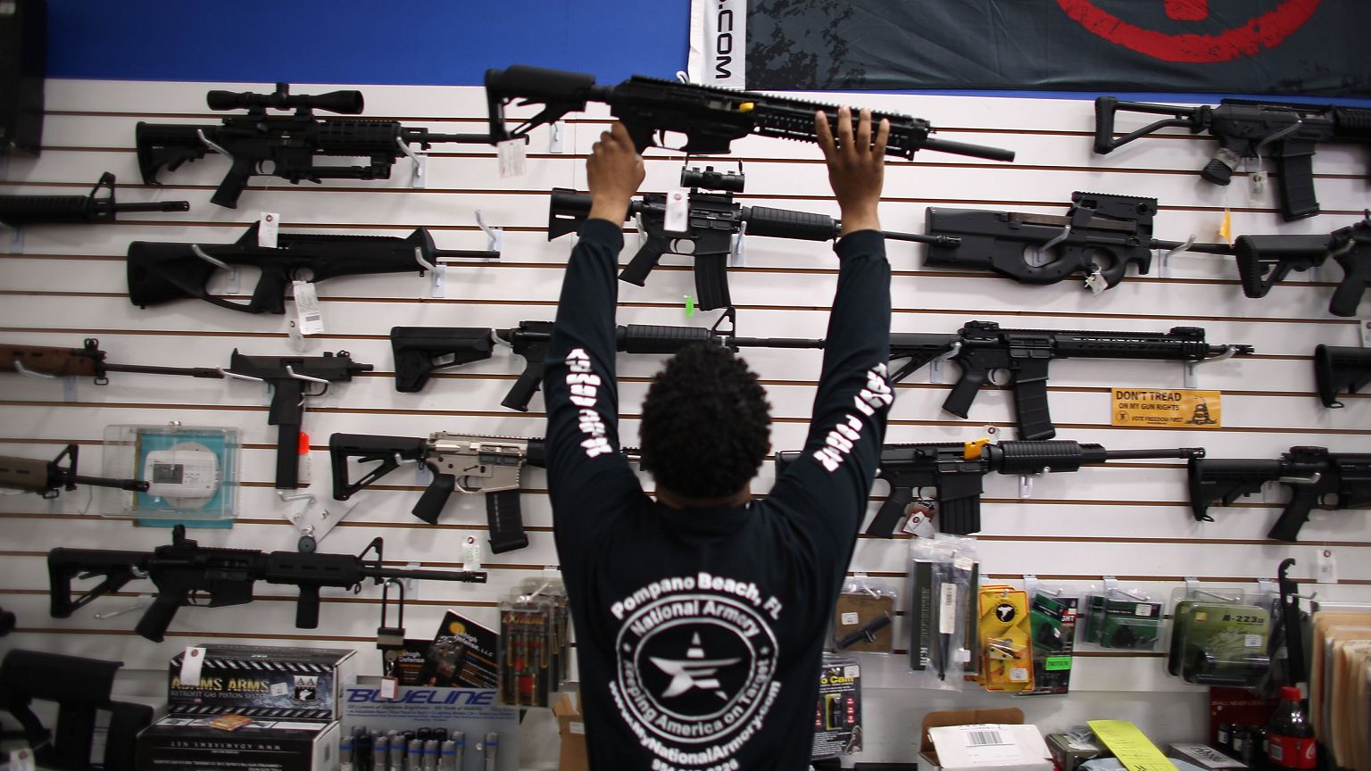 Image: Mike Acevedo Puts a Weapon on Display at the National Armory gun sto