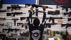 Image: Mike Acevedo Puts a Weapon on Display at the National Armory gun sto