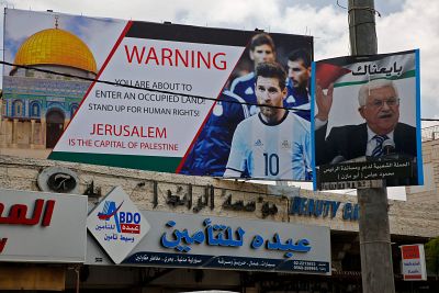 A sign erected in the West Bank town of Hebron called on Lionel Messi to boycott the match, which had been scheduled for Saturday.