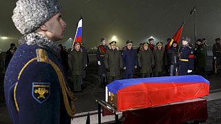 Body of Russian bomber pilot Oleg Peshkov arrives in Moscow