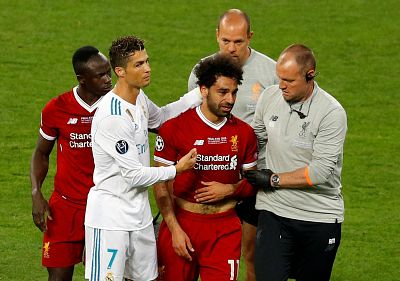 Liverpool\'s Mo Salah with teammate Sadio Mane and Real Madrid\'s Cristiano Ronaldo as he is substituted after sustaining an injury during the 2018 Champion\'s League final in Kiev, Ukraine.