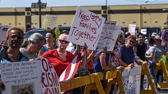 Image: Protesters hold signs in front of a Homeland Security facility in El