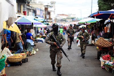Salvadoran soldiers patrol in downtown San Salvador after six market sellers were killed in San Salvador, El Salvador on March 15, 2017.