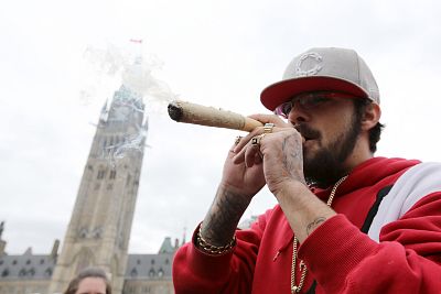 A man smokes marijuana on Parliament Hill in Ottawa.