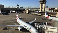 Image: An American Airlines plane sits at the gate at Dallas Fort Worth Int