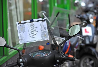 A Knowledge exam route sheet rests on a moped in north London. They are used by prospective cabbies to learn the city streets.