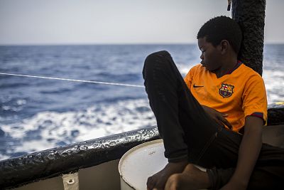 Khingsley Dokowada, 9, from the Central African Republic, rests on the deck of the Open Arms on Monday.